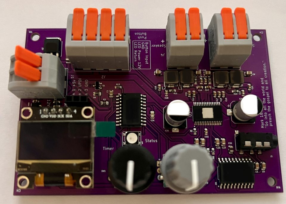 The Push Button Board, top view, with lever terminals, OLED screen, and timer and volume knobs